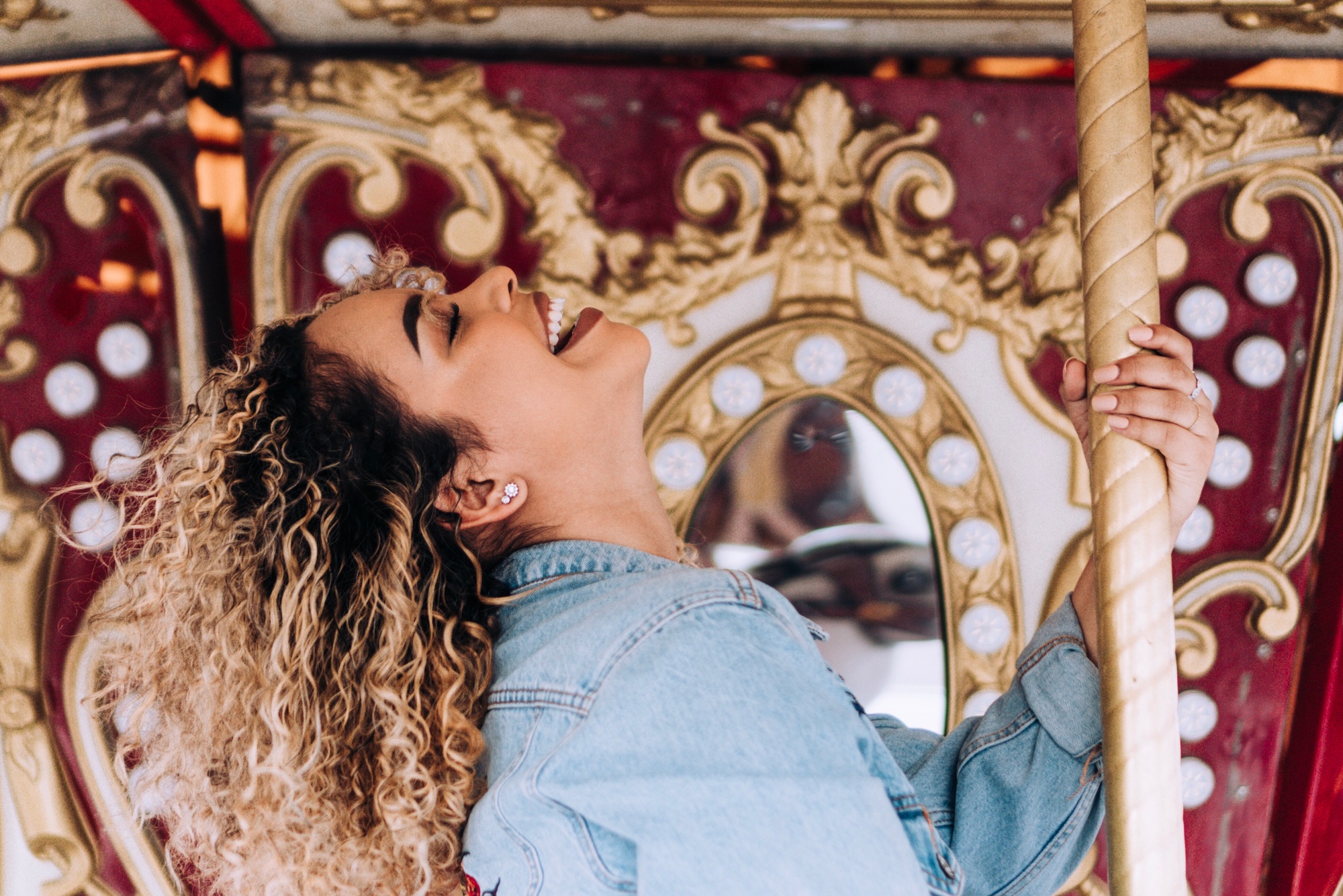 happy-young-woman-with-curly-hair-at-summer-fair